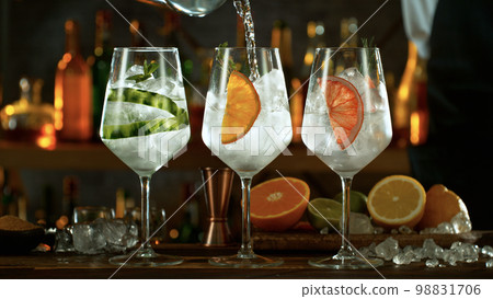 Fresh various gin tonic cocktails on the bar, dark toned background 98831706
