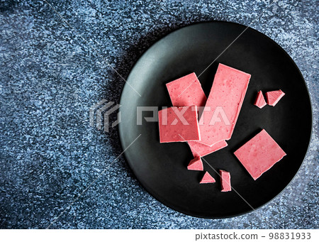 Pink or ruby chocolate, trendy dessert on a black plate, copy space Pink or ruby chocolate, trendy dessert on a black plate, copy space 98831933