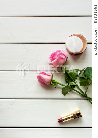 Top view arrangement with make-up, roses and copy-space on white wooden background Top view arrangement with make-up, roses and copy-space on white wooden background 98831962