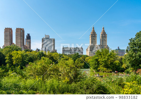 Skyline panorama with Eldorado building and reservoir with boats in Central Park in midtown Manhattan in New York City 98833182