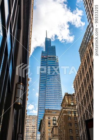 Beautiful bottom view of the skyscrapers from the narrow streets of New York 98833205