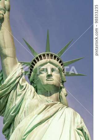 Close-up of the face and crown of the Statue of Liberty on a sunny day 98833235