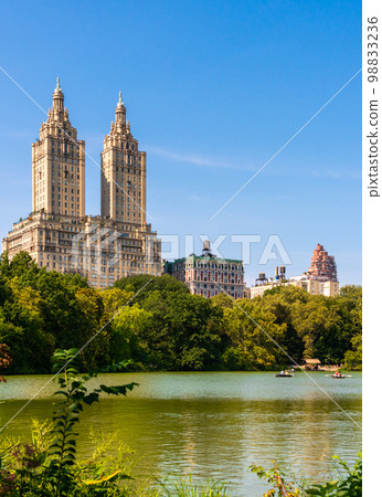 Lake with boats in Central Park in midtown Manhattan in New York City with Eldorado building 98833236