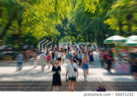 Crowd in Central park in New York, motion blur effect Crowd in Central park in New York, motion blur effect 98833282