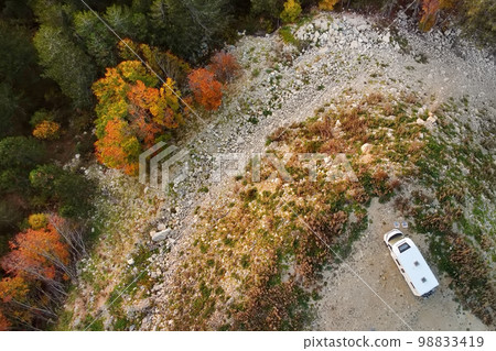 Drone aerial view of parked big modern camper motorhome. Family vacation travel RV. Bicycles attached to a caravan. Travel and adventure. Go everywhere 98833419