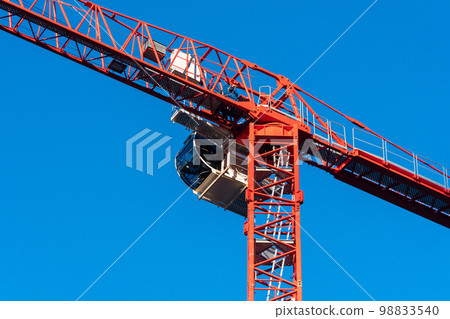 Construction crane against the blue sky. 98833540