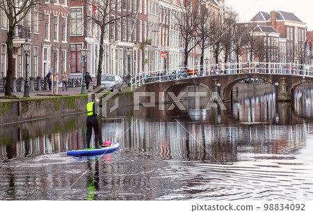 Beautiful old houses on the city embankment of Leiden Beautiful old houses on the city embankment of Leiden 98834092