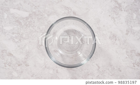 Flat lay. Step by step. Mixing ingredients to bake unicorn rainbow chocolate cupcakes. 98835197