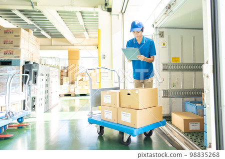 Male truck driver working in a warehouse Male truck driver working in a warehouse 98835268