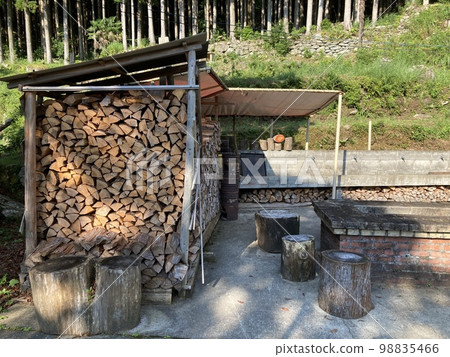 It is a lot of firewood stored for bathing in the mountain village of Kumano City, Mie Prefecture. It is a lot of firewood stored for bathing in the mountain village of Kumano City, Mie Prefecture. 98835466
