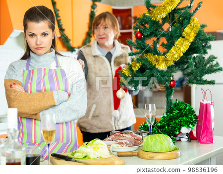 Women quarreling at kitchen 98836196