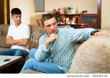 Sad man after discord with teen son 98836230