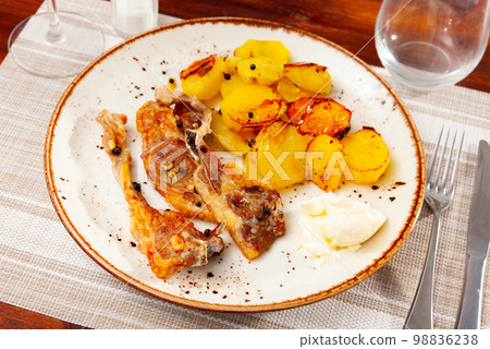 Grilled lamb ribs with french fries on plate 98836238