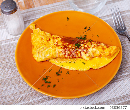 Portion of healthy omelet from lightly beaten eggs served for breakfast 98836277