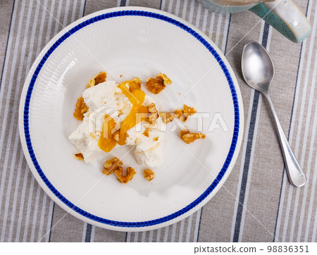 Mato served with honey and walnut on plate Mato served with honey and walnut on plate 98836351