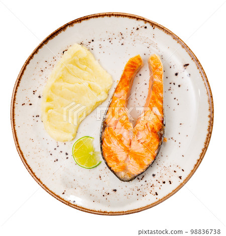 Fried salmon with mashed potato and lemon on white plate. Traditional spanish dish Fried salmon with mashed potato and lemon on white plate. Traditional spanish dish 98836738