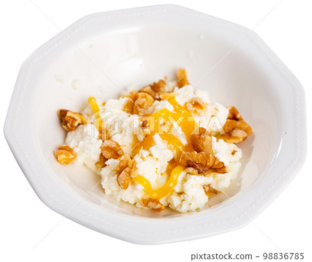 Catalan whey cheese, mato, served on plate with honey and walnuts Catalan whey cheese, mato, served on plate with honey and walnuts 98836785