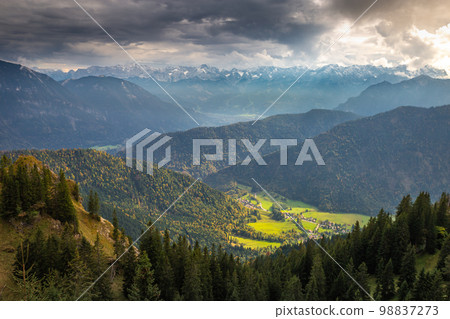 Bavarian alps and valleys from above at dramatic autumn sky, Garmisch, Germany Bavarian alps and valleys from above at dramatic autumn sky, Garmisch, Germany 98837273