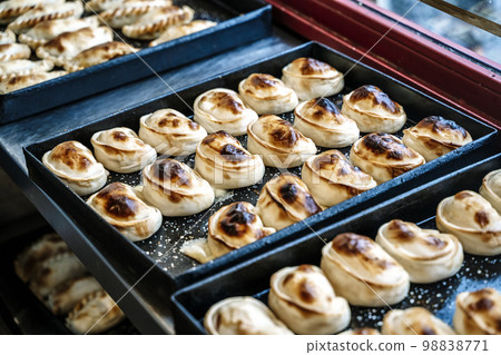 Empanadas on a table in a street cafe in Buenos Aires. Traditional food of Argentina and South America. Baked pies with meat. Empanadas on a table in a street cafe in Buenos Aires. Traditional food of Argentina and South America. Baked pies with meat. 98838771