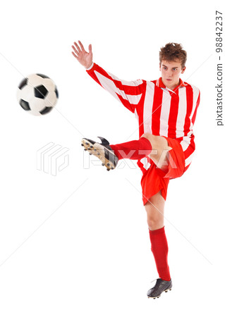 Soccer player kicking the ball 98842237