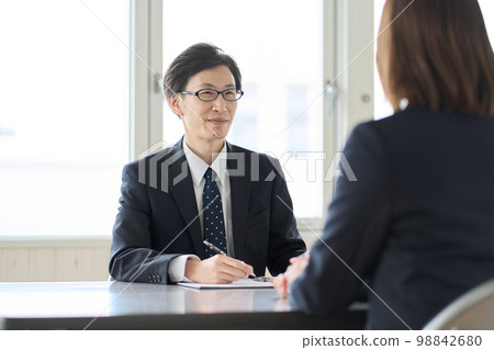 Asian male tax accountant receiving tax consultation 98842680