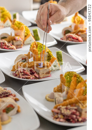 Chef placing a piece of decor flower Chef placing a piece of decor flower 98843722