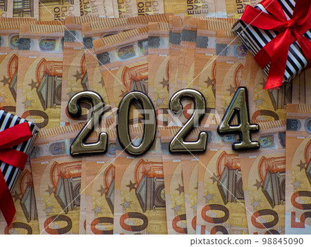 2024 and gift boxes on the background of fifty euros banknotes 98845090