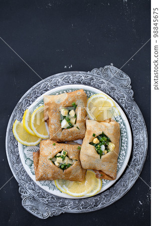 ruddy pancakes with fresh green onions and egg on a wooden background ruddy pancakes with fresh green onions and egg on a wooden background 98845675
