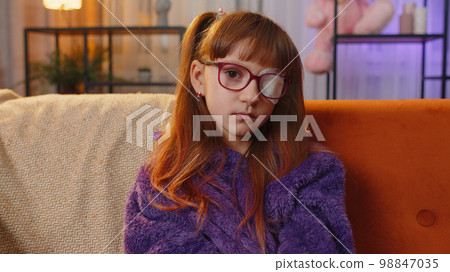 Sick ill preteen girl looking at camera, having protective bandage plaster patch scratch on one eye 98847035