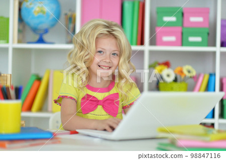 girl using laptop at desk at home girl using laptop at desk at home 98847116