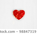 Valentine's Day concept. Red heart with the light string on the white wooden background. 98847319