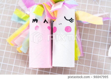 Flat lay. Making a unicorn out of the toilet paper roll and craft paper. 98847995