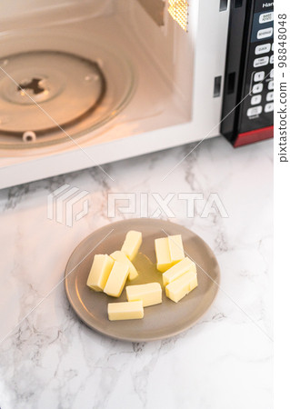 Softened sticks of unsalted butter on in the microwave. Softened sticks of unsalted butter on in the microwave. 98848048