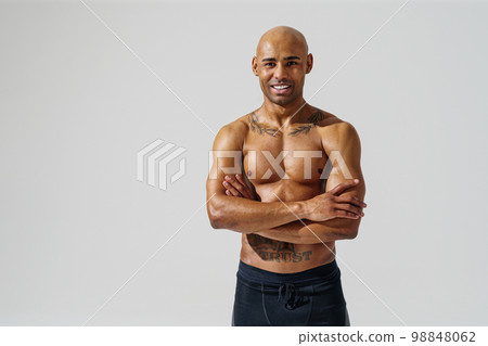 Portrait of smiling sporty man with muscled naked body on white studio background 98848062