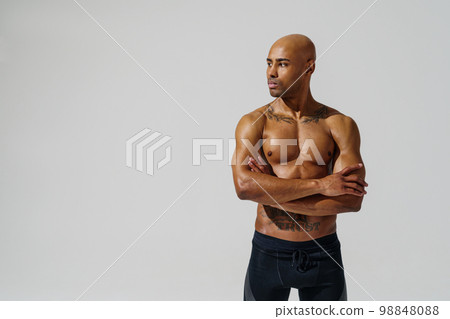 Portrait of attractive sporty man with muscled naked body on white studio background looking at side 98848088