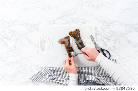 Flat lay. Preparing raw lobster tails to make garlic lobster tails. Flat lay. Preparing raw lobster tails to make garlic lobster tails. 98848586