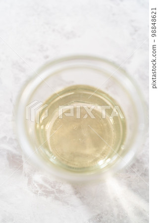 Freshly made simple syrup in a small glass jar. Freshly made simple syrup in a small glass jar. 98848621