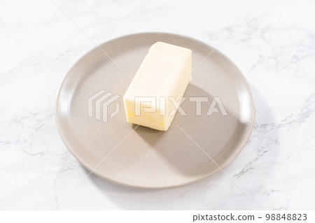 Sticks of unsalted butter on the small plates. Sticks of unsalted butter on the small plates. 98848823
