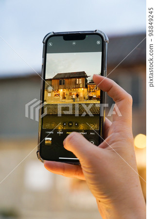 Shop house at Klong Maekha canal in Chiangmai, photo taken with hand holding and pressing mobile phone application as background Shop house at Klong Maekha canal in Chiangmai, photo taken with hand holding and pressing mobile phone application as background 98849245