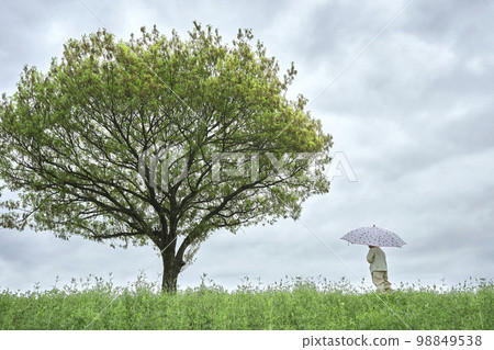一個孩子在外面撐傘的田野景觀 一個孩子在外面撐傘的田野景觀 98849538