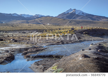 Geysers El Tatio with river and volcanic landscape at sunrise, Atacama, Chile 98849770