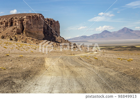 Dirt road in Moon Valley dramatic landscape at Sunset, Atacama Desert, Chile 98849913