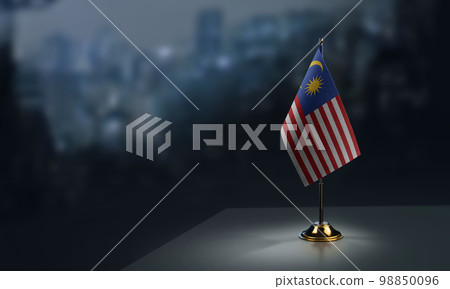 Small flags of the Malaysia on an abstract blurry background 98850096