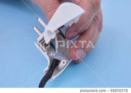 Installation of sectional European electric plug on an electrical cord. Installation of sectional European electric plug on an electrical cord. 98850576