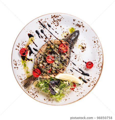 Portion of baked fish stuffed with vegetables Portion of baked fish stuffed with vegetables 98850758
