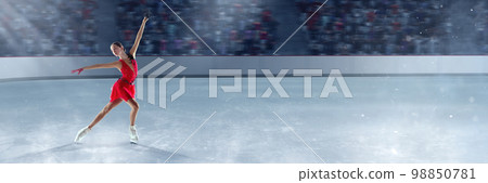 Beautiful girl in red dress, professional figure skater performing on dance competition, skating on 3D arena, ice rink. Graceful beauty 98850781