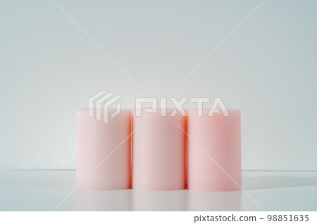 three new pink round candles in a row macro photo background. Cozy home interior design 98851635