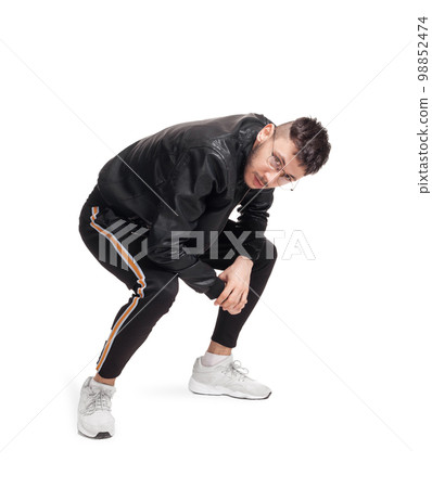 Full-length photo of a funny guy dancing in studio isolated on white background. 98852474