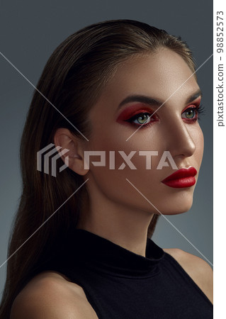 Close-up portrait of a beautiful fashion model with professional make-up. 98852573