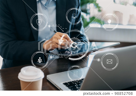 Copyright or patent concept, Person hand using laptop computer, tablet and smartphone with virtual screen copyright icon trademark, Creation ownership against piracy. at office.. 98852708